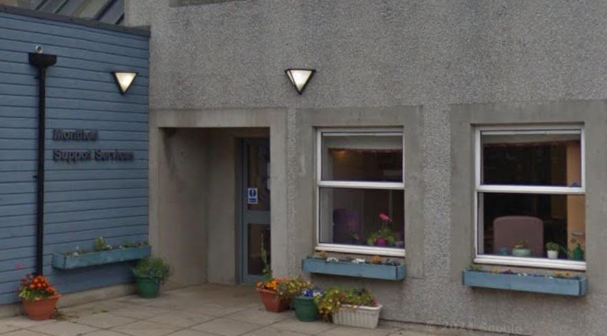 Picture of Montfield Support Services building with flowers in front